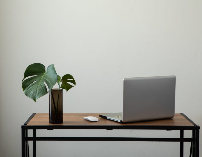 workspace white wall minimal with notebook and desk